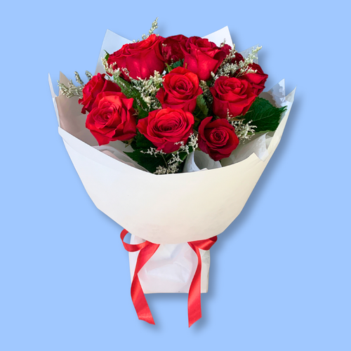 12 red roses bouquet wrapped in white with red stain bow. in a 360 degree round style. In a white water box, Rangiora florist