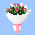 Half dozen pink roses in a white wrapped bouquet in a 360 degree round style. Pink bow.