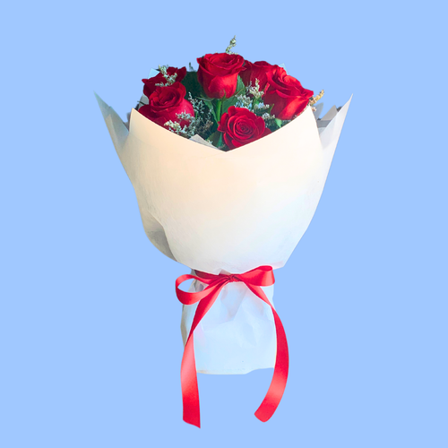Front facing view of 6 Red Roses wrapped in white in 360 degree round style. red satin bow. in waterbox