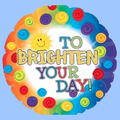 A round foil balloon with a scalloped edge, featuring a colorful rainbow border of swirls and a smiling sun, with the text 'TO BRIGHTEN YOUR DAY!' in multicolored letters on a white center, shown against a light blue background.