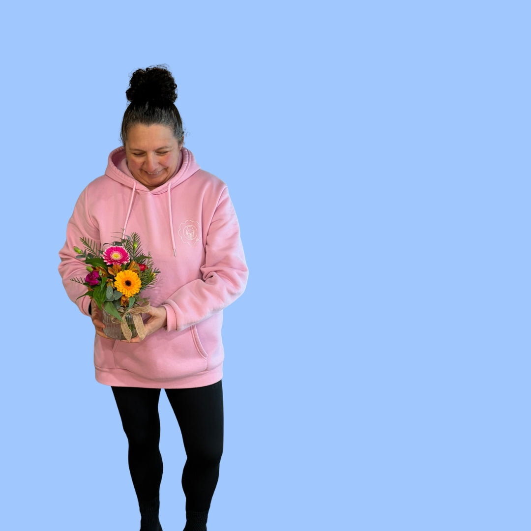 Laura King holding a Hand-tied bright seasonal posy in a vase