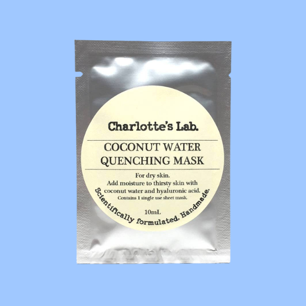 Charlotte's Lab Coconut Water Quenching Mask in a silver pouch with a large cream-colored circular label, set against a solid light blue background.
