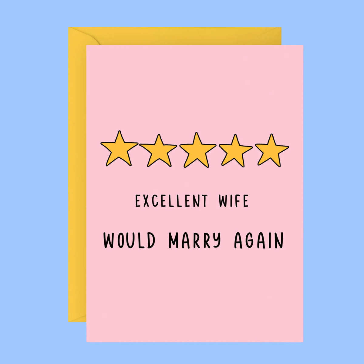 A pink greeting card with a yellow envelope behind it, featuring five yellow stars and the text 'EXCELLENT WIFE WOULD MARRY AGAIN' on a light blue background.