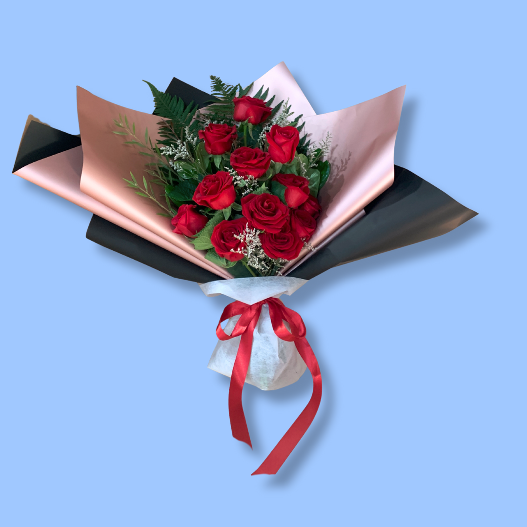 Elegant dozen red roses bouquet in black and rose gold wrap