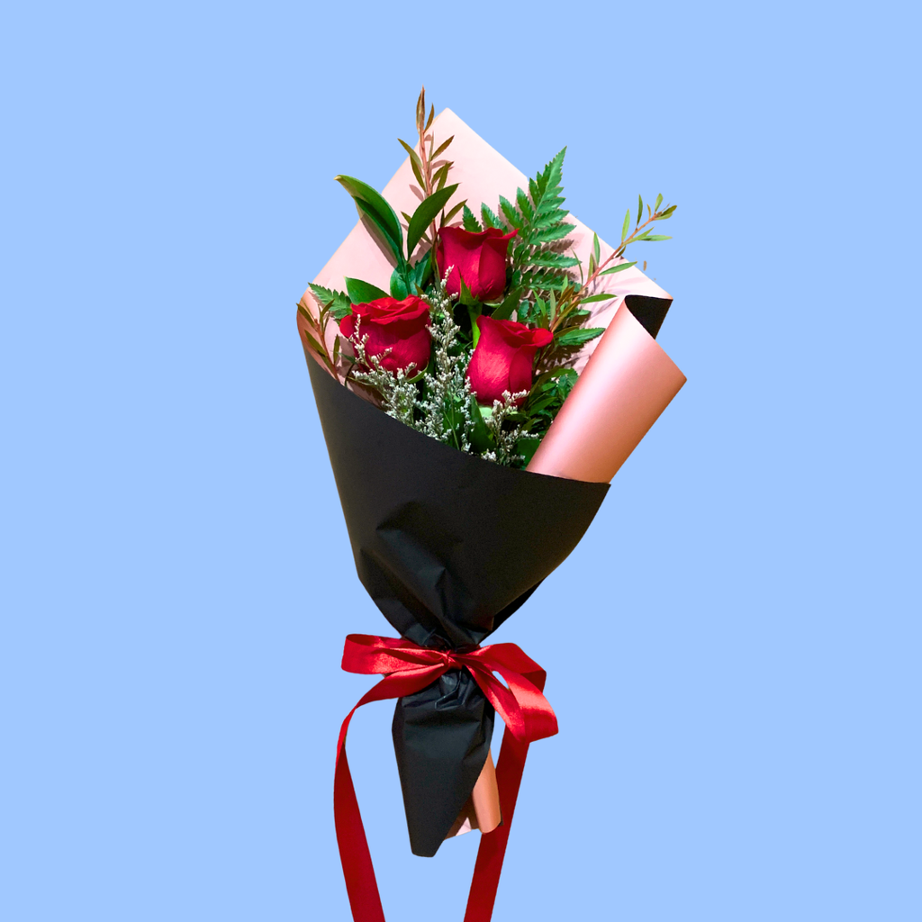 Elegant 3 red rose bouquet, wrapped in black and rose gold, with trailing satin ribbon