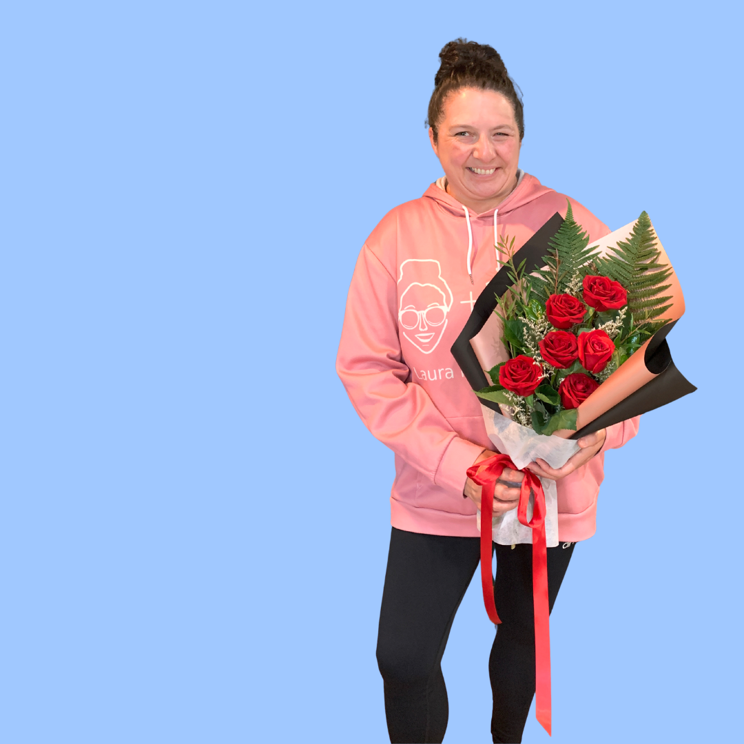 Laura King holding Elegant half dozen red roses bouquet, black and rose gold wrap