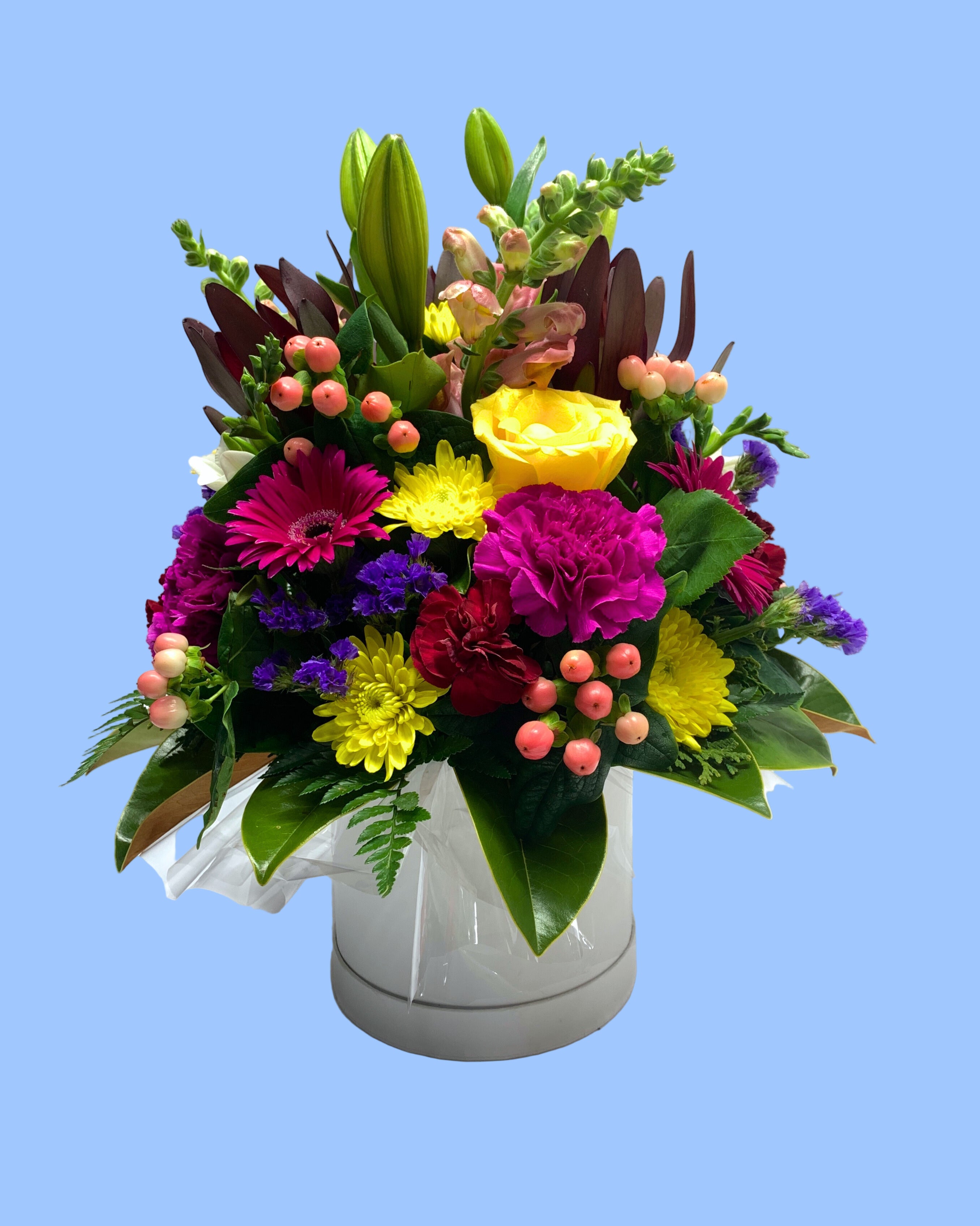Large Bold bright flower arrangement in cylindrical white hat box