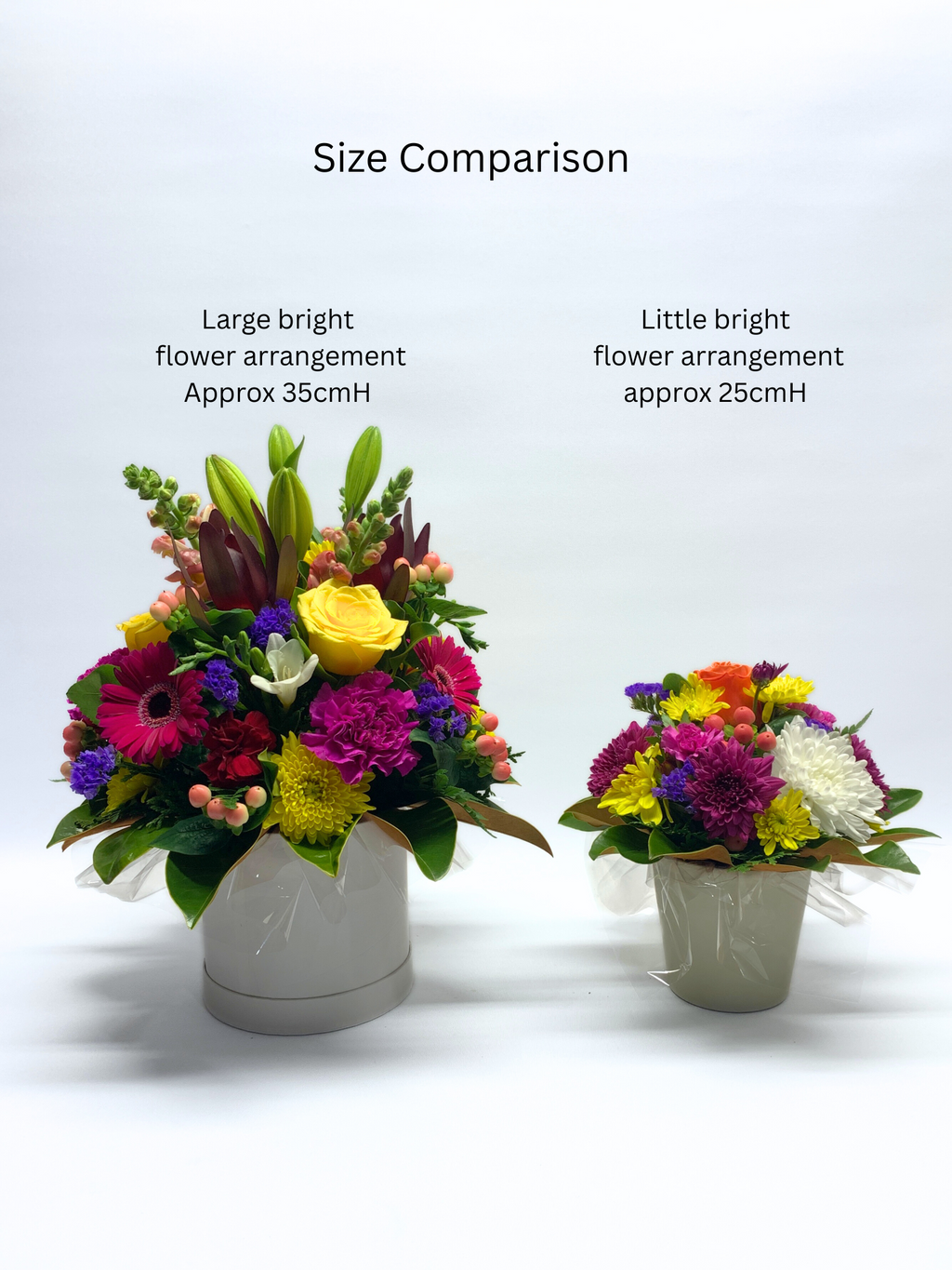 Picture showing a large bright flower arrangement in hat box and comparing it in size to the smaller little bight flower arrangement in the ceramic pot