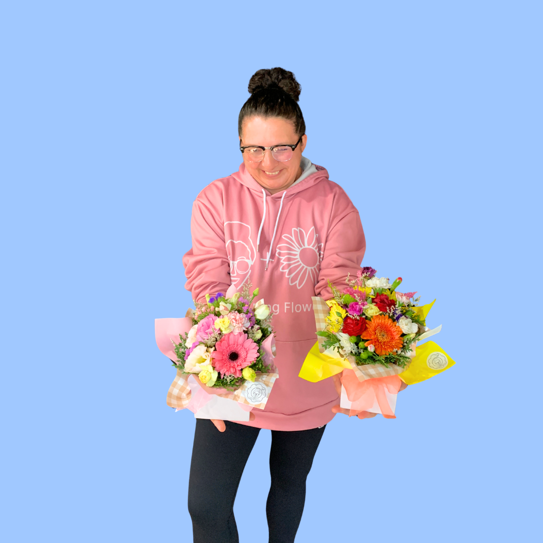 Laura King holding a small brights box arrangement and a small pastels box arrangement