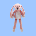 A pink plush bunny toy with long floppy ears, a white striped belly panel, and white striped paws and feet, shown against a solid light blue background.