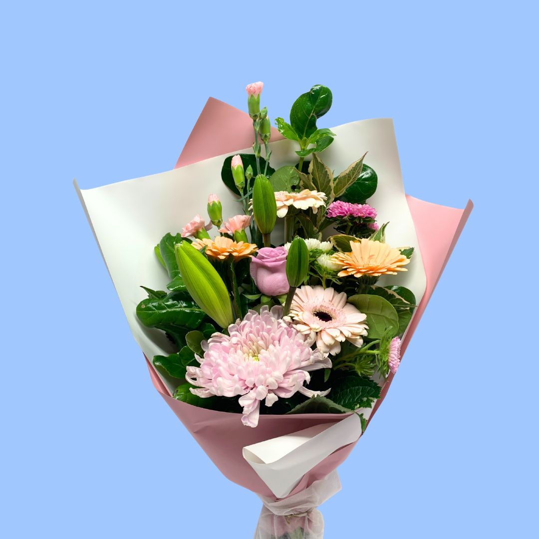 Pastels coloured flower bouquet wrapped in pink and white.