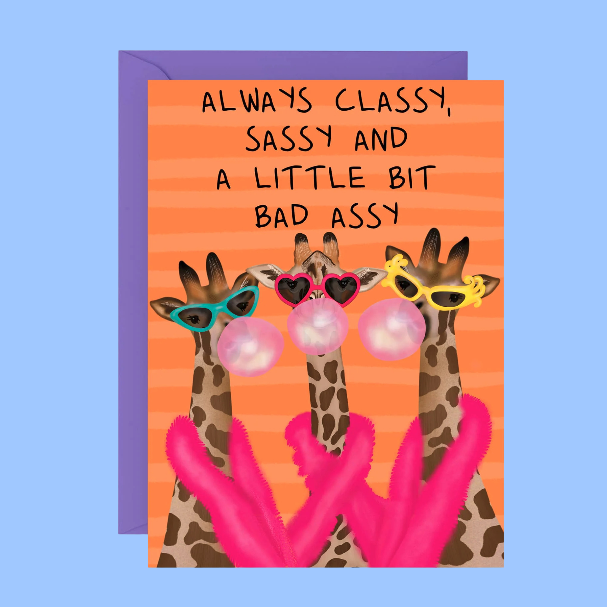 A greeting card with a purple envelope, featuring an illustration of three giraffes wearing colorful sunglasses and blowing pink bubblegum bubbles, with the text 'ALWAYS CLASSY, SASSY AND A LITTLE BIT BAD ASSY' on an orange striped background.