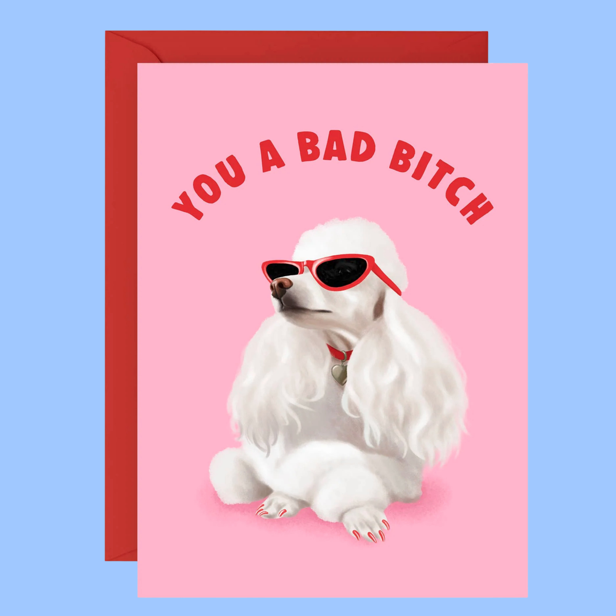 A pink greeting card with a red envelope behind it, featuring an illustration of a white poodle wearing red sunglasses and the text 'YOU A BAD BITCH' in red arched lettering. The card is shown against a light blue background.