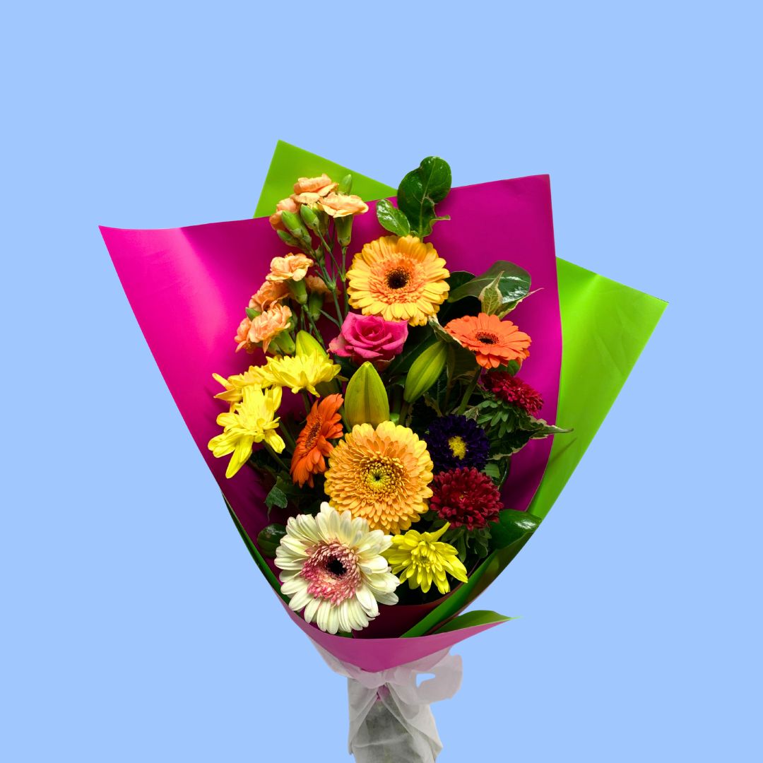 Bouquet of colorful flowers wrapped in pink paper and lime green.