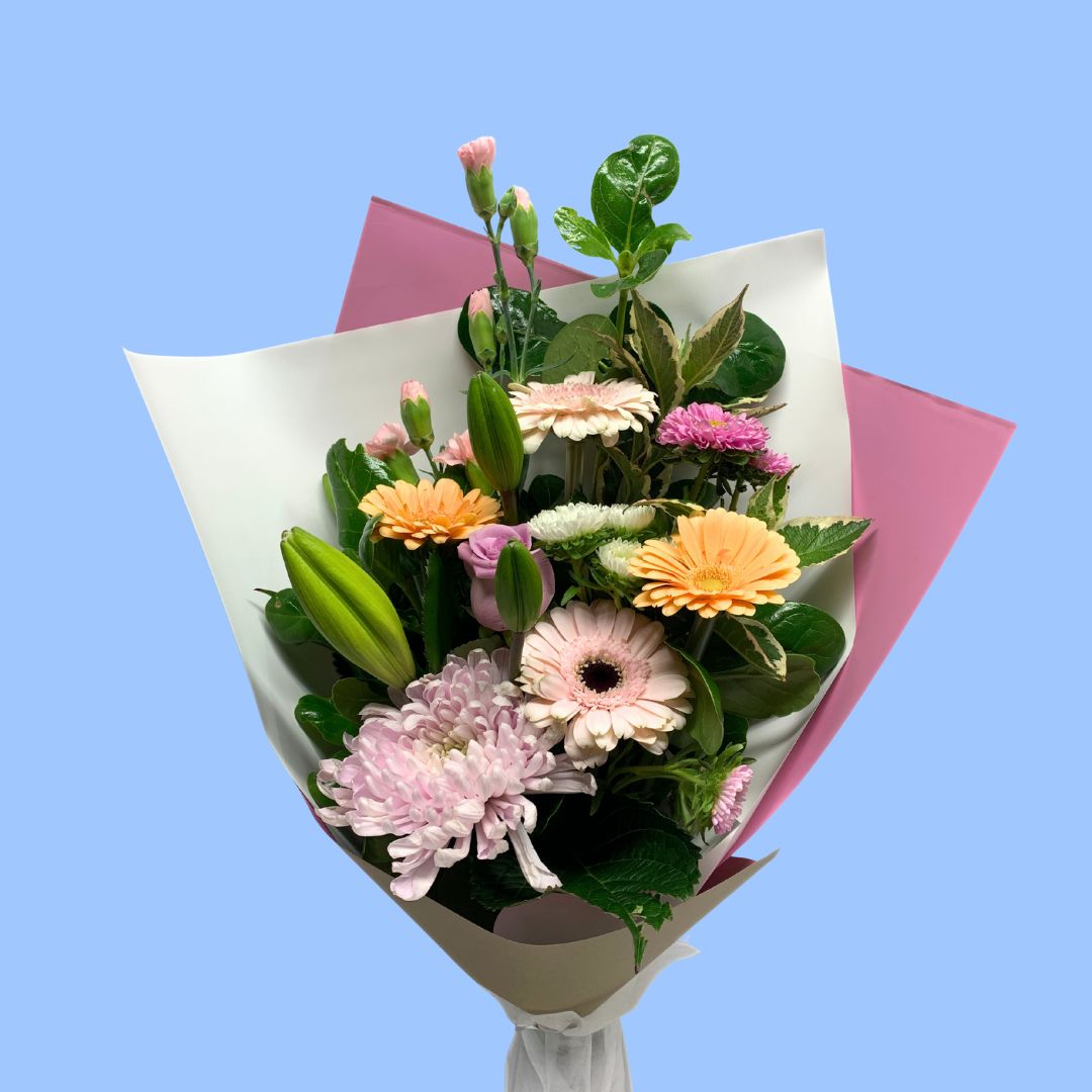 pastel coloured flower bouquet wrapped in kraft and pink
